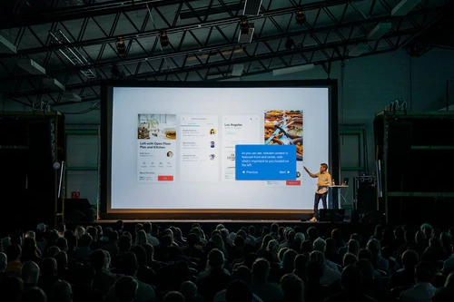 a man giving a presentation in front of a crowd